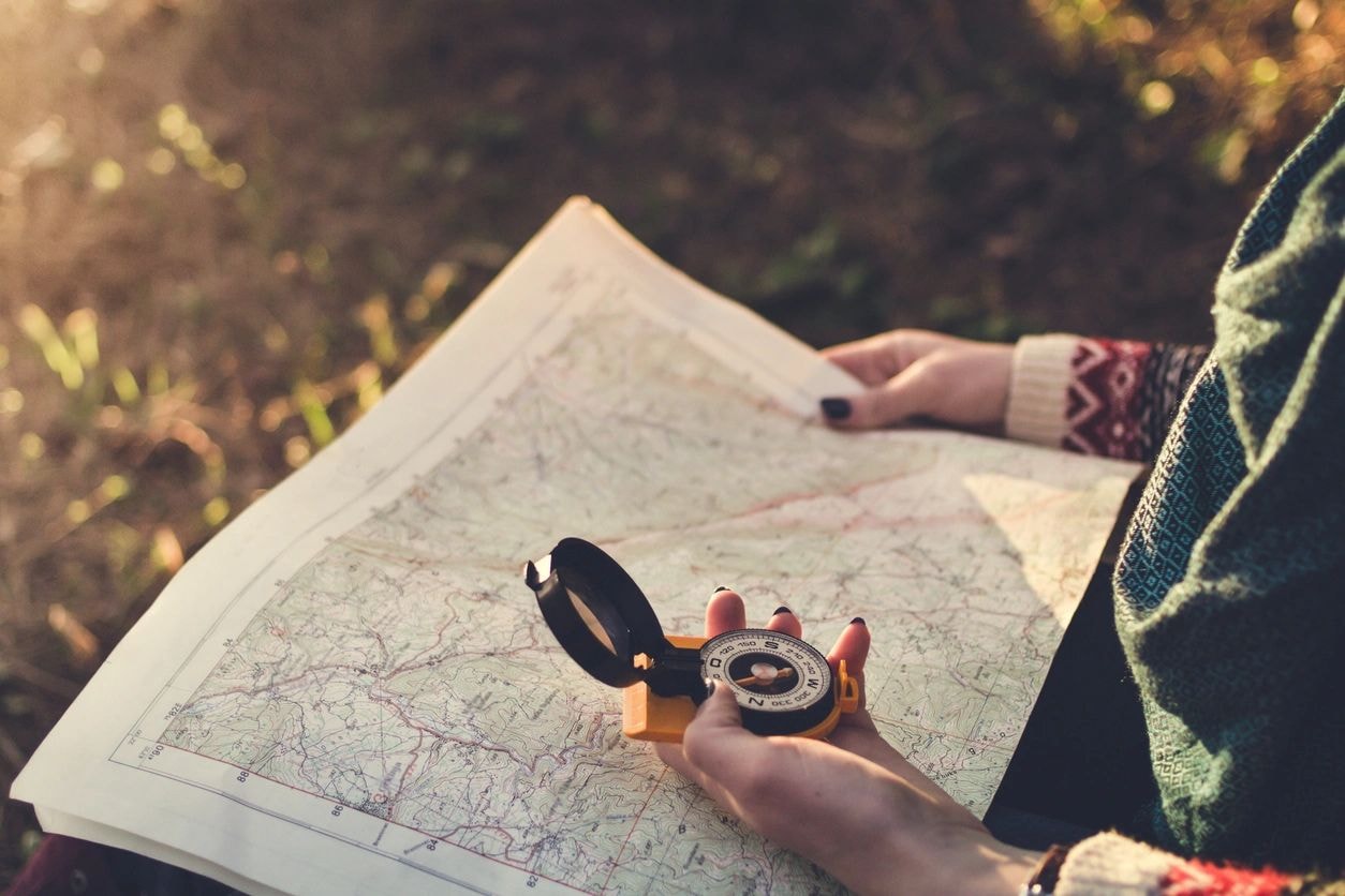 A compass over a map, representing focus and direction